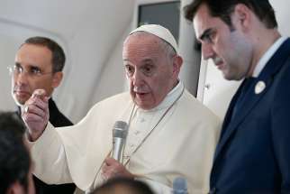  Pope Francis answers questions from journalists aboard his flight from Abu Dhabi, United Arab Emirates, to Rome Feb. 5, 2019. Also pictured are Msgr. Mauricio Rueda, papal trip planner, and Alessandro Gisotti, interim Vatican spokesman. 