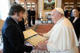 Argentine President Javier Milei gives Pope Francis a folder with a copy of a handwritten letter from 1854 accrediting Juan Bautista Alberdi as Argentina&#039;s representative in Europe during a private audience at the Vatican Feb. 12, 2024.