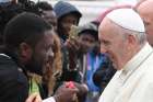 Pope Francis greets people at the &quot;Regional Hub,&quot; a government-run processing center for migrants, refugees and asylum seekers, in Bologna, Italy, Oct. 1.