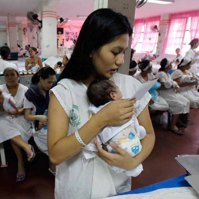 Mothers with their newborns wait for checkups at Jose Fabella Memorial Hospital in Manila, Philippines, in August. Legislation that would promote artificial contraception as a family planning method in the nation passed in the country&#039;s House of Represen tatives Dec. 13. The reproductive health bill faced fierce opposition from Catholic bishops and religious groups.