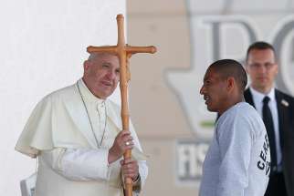Pope Francis accepts a crucifix from a prisoner as he visits Cereso prison in Ciudad Juarez, Mexico, Feb. 17.