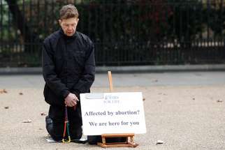 An activist prays outside an abortion clinic in London March 14, 2012. A council in London could become the second local authority in the U.K. to approve an exclusion zone around an abortion clinic.
