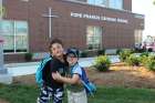 Children posing in front of the newly built Pope Francis Catholic School in York Region