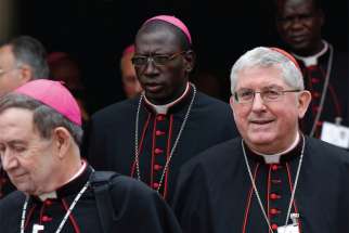 Cardinal Thomas Collins of Toronto, right, leaves a session of the Synod of Bishops on the family at the Vatican Oct. 9. Aubert Martin