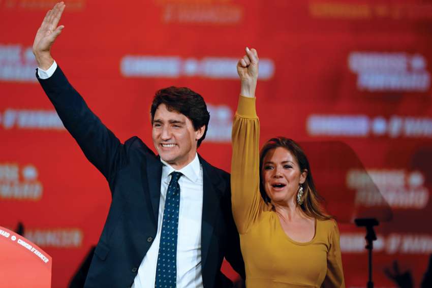 Prime Minister Justin Trudeau and his wife, Sophie Gregoire Trudeau, wave to supporters at the Palais des Congres in Montreal after claiming victory in the election.