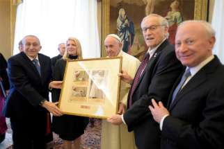 Pope Francis accepts a gift as he leads a meeting with a delegation from the Simon Wiesenthal Center, an international Jewish human rights organization, at the Vatican Jan. 20, 2020. The pope told the group, &quot;I will never tire of firmly condemning every form of anti-Semitism.&quot;