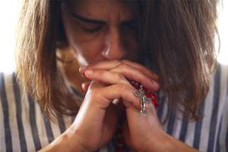 A woman holding a rosay prays during Mass at a church in Beirut Aug. 9, 2020. The church was damaged five days earlier in explosions in Beirut&#039;s port area. Cardinal Bechara Rai, Maronite patriarch, described the shrinking presence of Christians in the Middle East as a sinking ship to leaders of the Middle East Council of Churches Sept. 18.