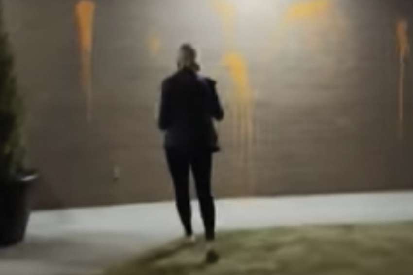 One of two women is caught in action as she splashes orange paint on a Vancouver church. Two women are facing charges. Over the summer, 13 Vancouver churches were vanadlized.