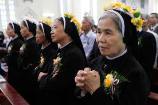 Nuns attend a Mass for the profession of vows for the Lovers of the Holy Cross of Hung Hoa Sisters in Son Tay, Vietnam, Oct. 29, 2011.