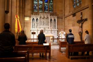 People maintain social distancing as they attend Mass at St Mary&#039;s Cathedral in Sydney May 15, 2020, during the COVID-19 pandemic.