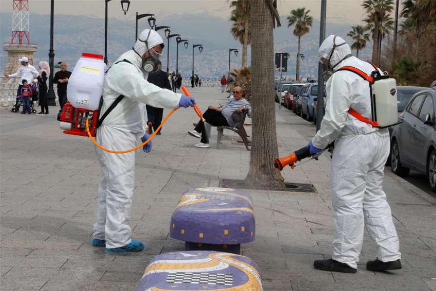 Employees from a disinfection company sanitize a bench as a precaution against the spread of the coronavirus in Beirut March 5, 2020. The number of cases is steadily increasing in Lebanon, which announced its second death from COVID-19 March 11.