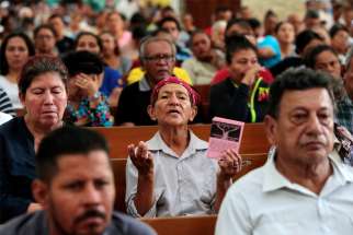 A woman prays during a Mass at the Metropolitan Cathedral in Managua, Nicaragua Nov. 21, 2019. Catholics in Nicaragua are calling for the release of two priests detained over the past two months in as a campaign of arbitrary arrests and church repression continues in the Central American country.