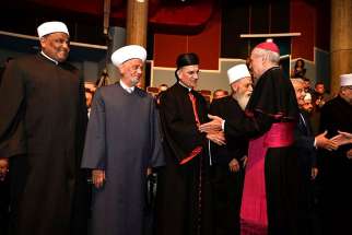 The Vatican&#039;s nuncio to Lebanon, Archbishop Gabriele Caccia, greets religious leaders during an interfaith conference at Notre Dame University Louaize in Zouk Mosbeh, Lebanon, July 1.
