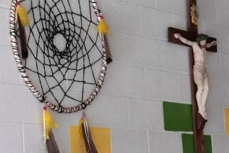 A dream catcher and crucifix are seen on the wall of a school on the Zuni Pueblo Indian reservation in New Mexico in this 2011 file photo.