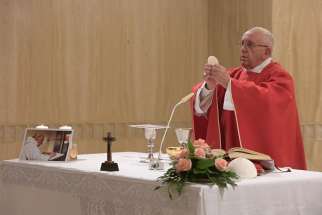  Pope Francis celebrates a memorial Mass for Father Jacques Hamel in the chapel of the Domus Sanctae Marthae at the Vatican Sept. 14. Father Hamel, seen in the photo on the altar, was murdered while celebrating Mass in Rouen, France, July 26; the two killers claimed allegiance to the Islamic State group.