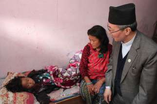 Bishop Paul Simick of Nepal visits 4-year-old Catholic Sujina Ghale and her mother, Chaju Ghale, in Banyatar, Nepal, April 30. Sujina was presumed dead and was kept among dead bodies for cremation after she was pulled out of the debris of the house following the April 25 earthquake.