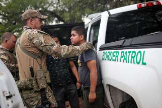 Members of the Border Patrol Search, Trauma, and Rescue Unit near Falfurrias, Texas, apprehend an immigrant from Guatemala June 19. Pope Francis told Reuters he stands with the U.S. bishops in their condemnation of the Trump administration&#039;s immigration policy has led to children being held in government shelters while their parents are detained in federal prison. 