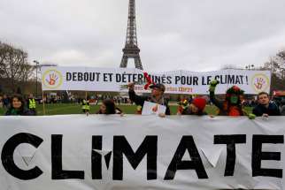 Environmentalists protest near the Eiffel Tower in Paris as the U.N. climate conference ended Dec. 12, 2015.