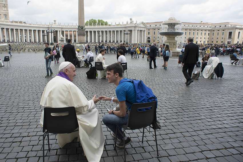 Pope Francis hears confession of a youth April 23, 2016 in St. Peter&#039;s Square at the Vatican. 