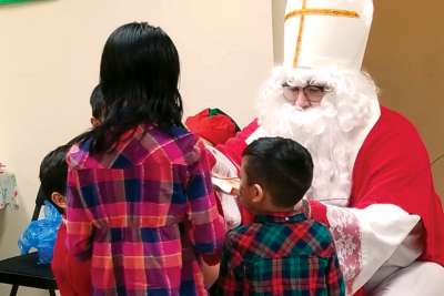 St. Nicholas is deep in conversation with some of the younger guests at the Baby Jesus Party put on by the Daughters of St. Paul in Toronto on Dec. 7.