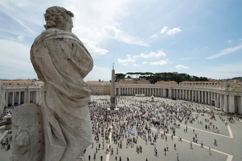 People gather in St. Peter’s Square.