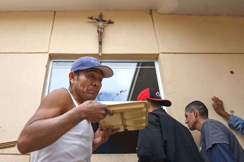 Migrants receive food at San Jose Obrero Parish in Mexicali, Mexico, Feb. 26. Between 60 and 80 migrants receive food at the parish every day.