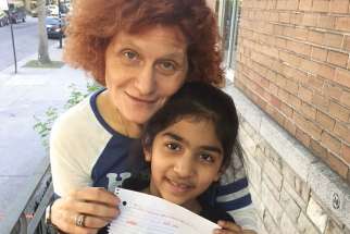 Alessandra Santopadre with a child the Montreal archdiocese’s refugee office is helping as her family seeks refugee status. 