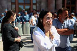 A woman reacts as protesters gather Sept. 20, 2023, near a government building in Yerevan, Armenia, following the launch a day earlier of a military operation by Azerbaijani forces in Nagorno-Karabakh. A ceasefire was declared Sept. 20 in the region, which is a historic Armenian enclave located in southwestern Azerbaijan and internationally recognized as part of that nation.