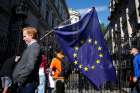 A man carries a European Union flag in London June 24, a day after voters in the United Kingdom decided to leave the EU.