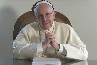 A screenshot shows Pope Francis smiling during a video message from the Vatican to young people of the Caribbean attending the July 10-23 youth assembly sponsored by the Antilles bishops&#039; conference. 
