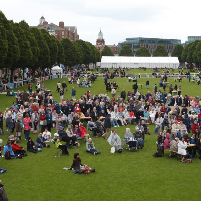 People gather on the lawn of the Royal Dublin Society as they listen to a lecture during the 50th International Eucharistic Congress in Dublin June 14. 