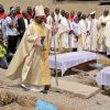 Bishop Martin Igwemezie Uzoukwu of Minna, Nigeria, walks near the coffins of some the victims of a Christmas bombing at St. Theresa Catholic Church in Madalla, Nigeria, during a funeral for the victims Feb. 1.