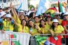 Pilgrims wave prior to the opening Mass for World Youth Day at Eduardo VII Park in Lisbon, Portugal, Aug. 1, 2023.