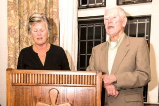 Barb and Mike McManus speak from behind the ambo that was presented to them upon their retirement from the National Catholic Broadcasting Council Nov. 11. The ambo will remain in the chapel of Loretto Abbey where the Daily Mass is broadcast from.