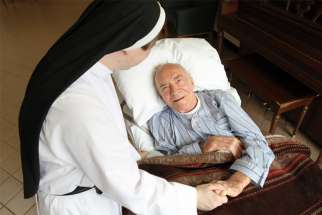  A patient is pictured in a file photo chatting with a nun at Rosary Hill Home, a Dominican-run facility in Hawthorne, N.Y., that provides palliative care to people with incurable cancer and have financial need.