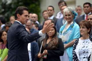 Mexican President Enrique Pena Nieto speaks with citizens in late May outside the presidential residence in Mexico City. How much the same-sex marriage issue and Catholic Church intervention, along with the intervention from evangelical congregations, swayed Mexico&#039;s recent elections remains disputed.
