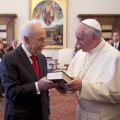 Israeli President Shimon Peres hands a copy of the Scriptures in English and Hebrew to Pope Francis during a private meeting at the Vatican April 30. Peres officially invited the pope to Israel and left their meeting telling him, &quot;I am expecting you in Jerusalem and not just me, but all the people of Israel.&quot;