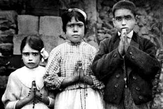 Portuguese shepherd children Lucia dos Santos, center, and her cousins, Jacinta and Francisco Marto, are seen in a file photo taken around the time of the 1917 apparitions of Mary at Fatima.