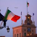 Italian flags blow in the breeze outside the presidential palace in Rome Dec. 22. When Italians go to the polls Feb. 24, the pope and other church officials will be watching closely.