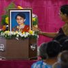 A woman puts flowers on the coffin of Jacintha Saldanha at Our Lady of Health Church in Shirva, India, Dec. 17.The body of Saldanha, the nurse who committed suicide in London after falling for a hoax by Australian radio announcers, was buried in her hus band&#039;s native village.