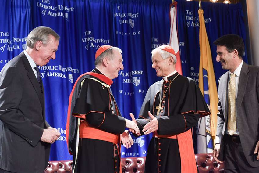 Vatican secretary of state, Cardinal Pietro Parolin, centre, is congratulated by John Garvey, president of The Catholic University of America, Washington Cardinal Donald W. Wuerl, and Andrew Abela, the university&#039;s provost, after receiving an honorary doctorate of theology Nov. 14, 2017, at the university. 