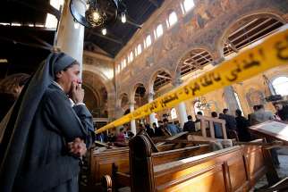 A nun cries as she stands inside St. Mark&#039;s Coptic Orthodox Cathedral Dec. 11, 2016 after an explosion inside the cathedral complex in Cairo. A bomb ripped through the complex, killing at least 25 people and wounding dozens, mostly women and children.