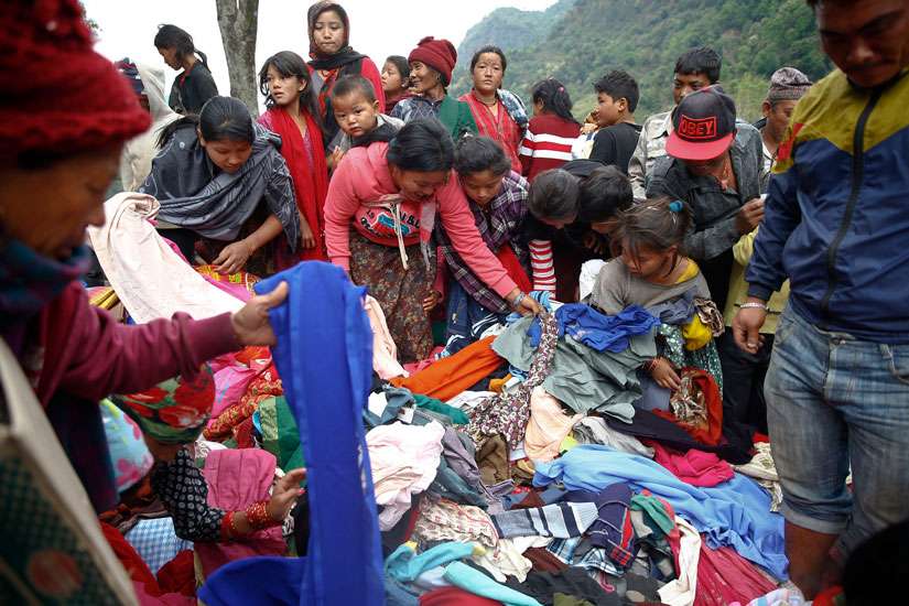 Earthquake survivors select clothes from a relief material delivery near Gorkha, Nepal, May 1. 