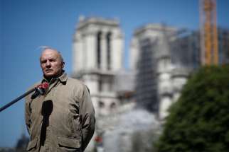 French Army Gen. Jean-Louis Georgelin, in charge of the Notre Dame Cathedral reconstruction, stays at a distance to answer journalists&#039; questions in Paris April 14, 2020, during the coronavirus pandemic. French President Emmanuel Macron has reiterated a pledge to restore the historic cathedral by 2024.