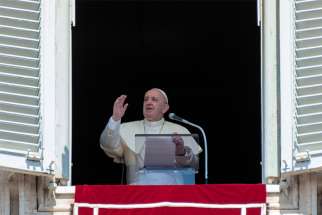 Pope Francis offers a blessing from a window overlooking St. Peter&#039;s Square at the Vatican during his Aug. 15, 2020, Angelus on the feast of the Assumption of Mary.