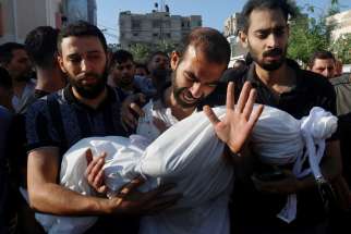 The father of Alma Al Majayda, 3, killed in an Israeli airstrike, reacts while carrying her body during the child’s funeral in Khan Younis in the southern Gaza Strip Oct. 19, 2023, amid the ongoing conflict between Israel and the Palestinian Islamist terrorist group Hamas.