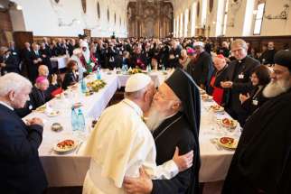 Pope Francis is greeted by Ecumenical Patriarch Bartholomew of Constantinople during an interfaith peace gathering Sept. 20 at the Basilica of St. Francis in Assisi, Italy. During the gathering Pope Francis invited refugees to lunch with him.