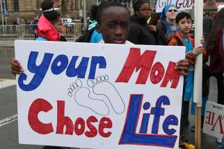 A young boy holds a pro-life sign during Ottawa&#039;s 21st annual March for Life May 10.