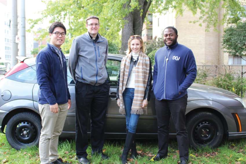 OCY missionaries with their new Ford Focus, donated by Fr. Scott Burchill outside of Serra House. From left, Francis Yoo, Burchill, Veronica Stach and Andre Tyson. 