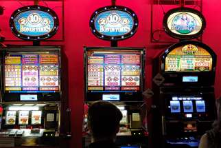 A man gambles on casino slot machines. 